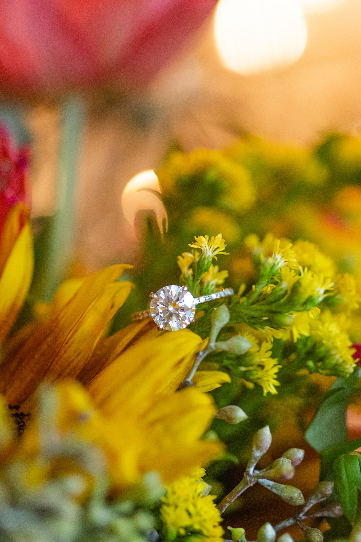 An engagement ring sits on some colorful flowers wedding venues in northern virginia